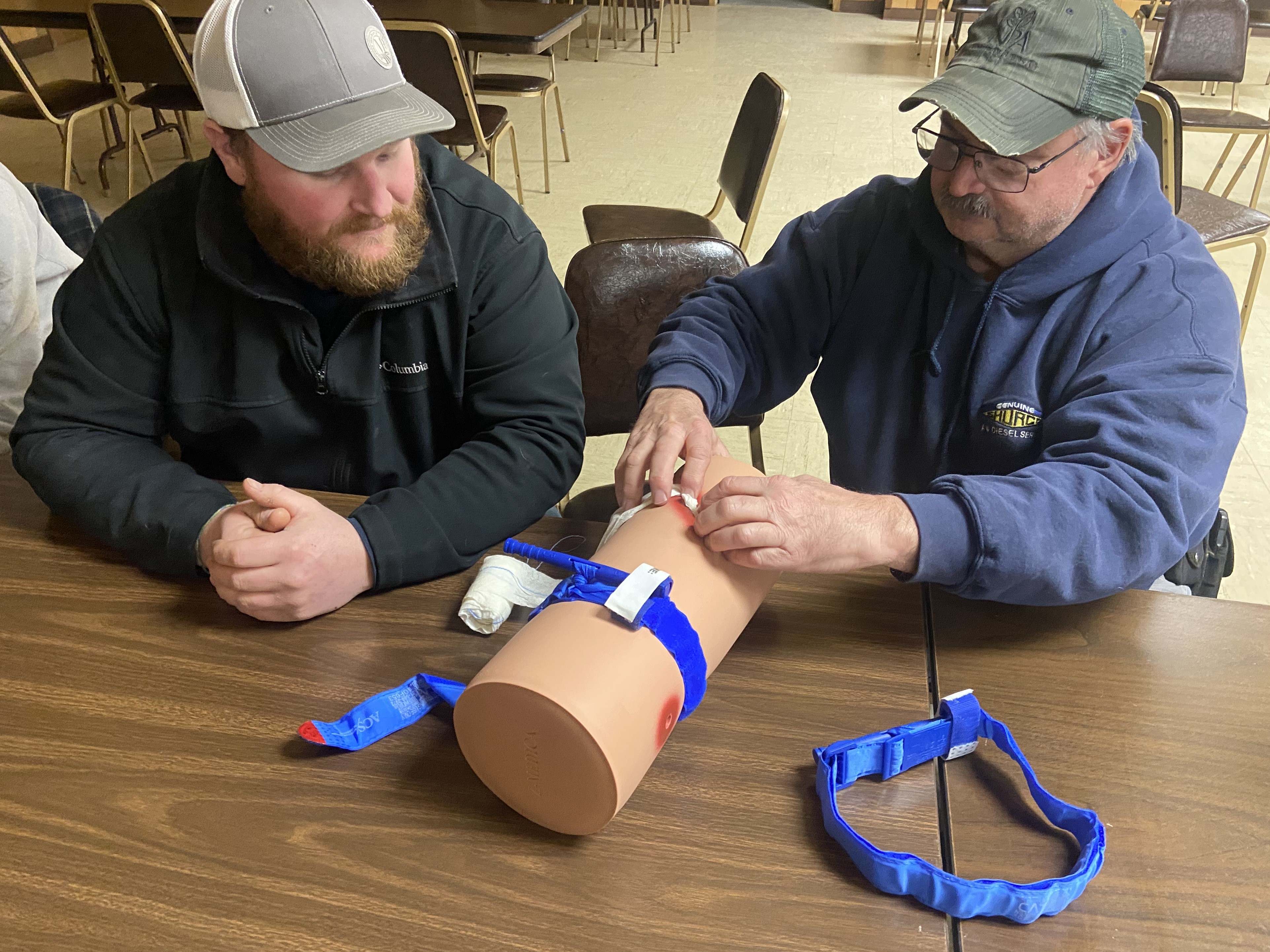 Participants at a Stop the Bleed training practice properly using a tourniquet in the event of blood loss caused by an injury. (NDSU photo)