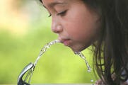 girl drinking water from fountain.jpg