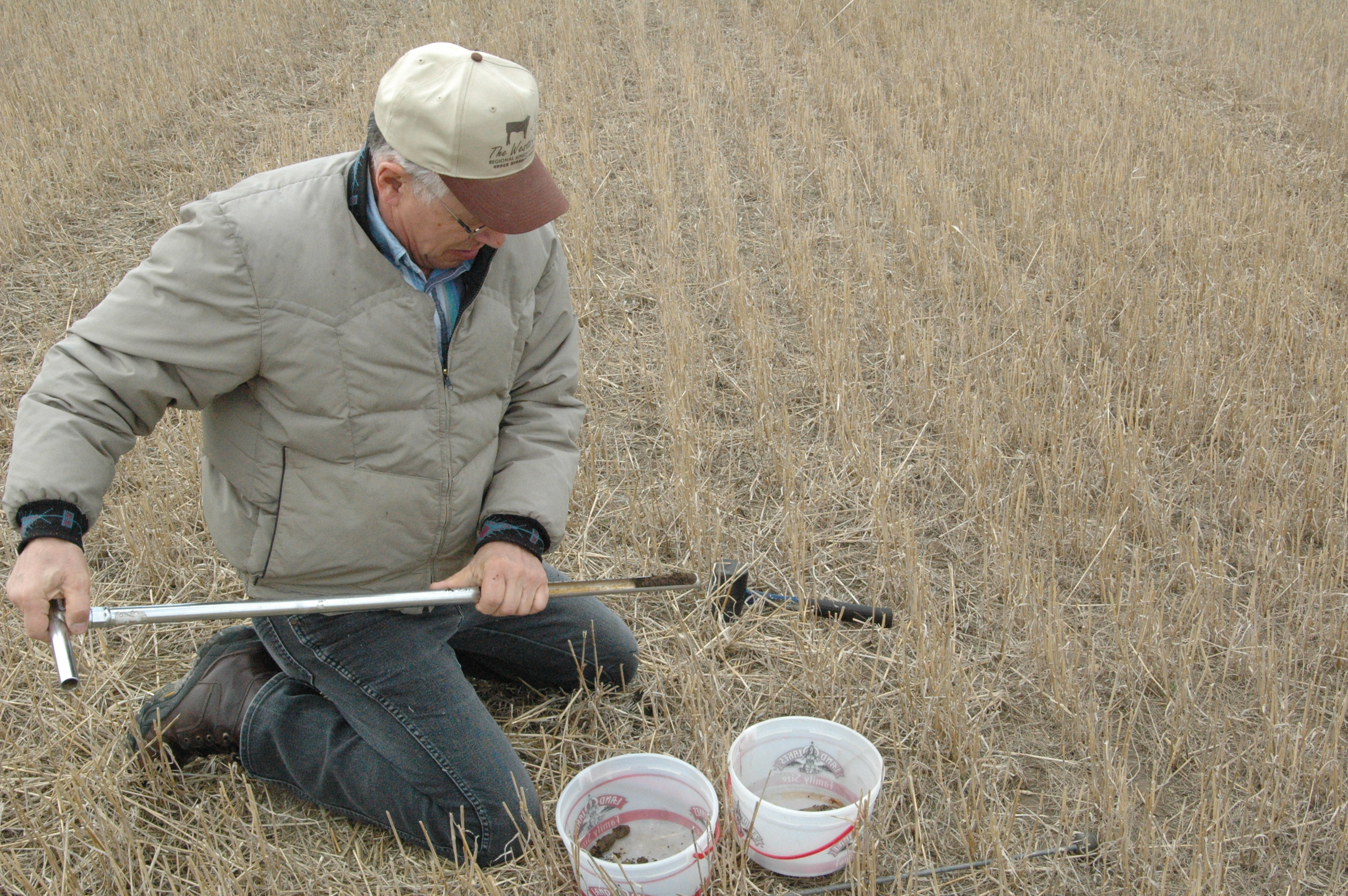 Williams County Extension agent Warren Froelich takes a soil sample.
