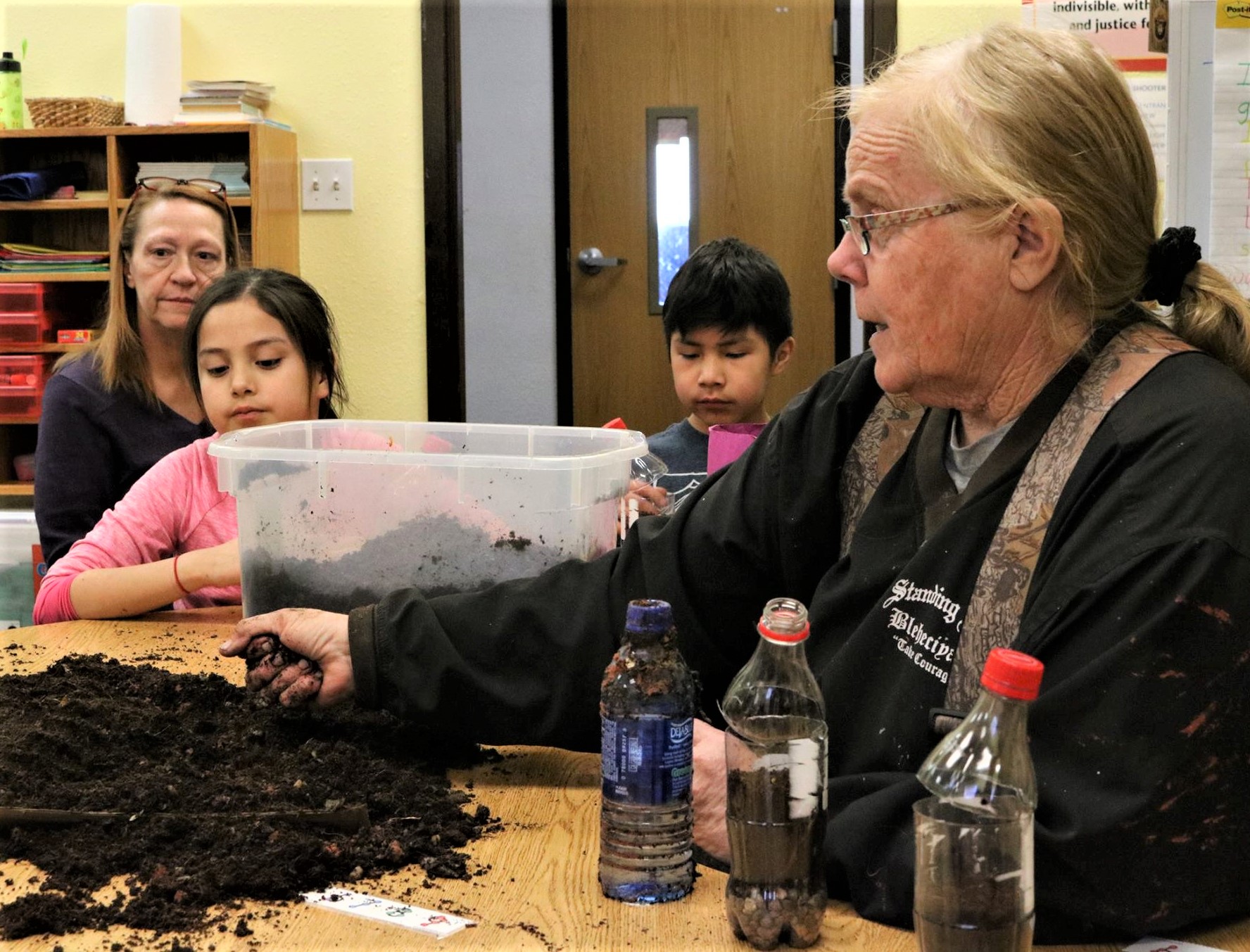 Sue Isbell, NDSU Extension - Sioux County agent, visits with youth during a science day camp. (NDSU Photo)
