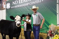 Representative Karen Rohr of Mandan, North Dakota, and her 4-H coach Jarett Sanders of Oliver County, display her new beef cattle showmanship skills at the photo backdrop during the 2024 North Dakota Public Leaders Showmanship Contest. (NDSU photo)