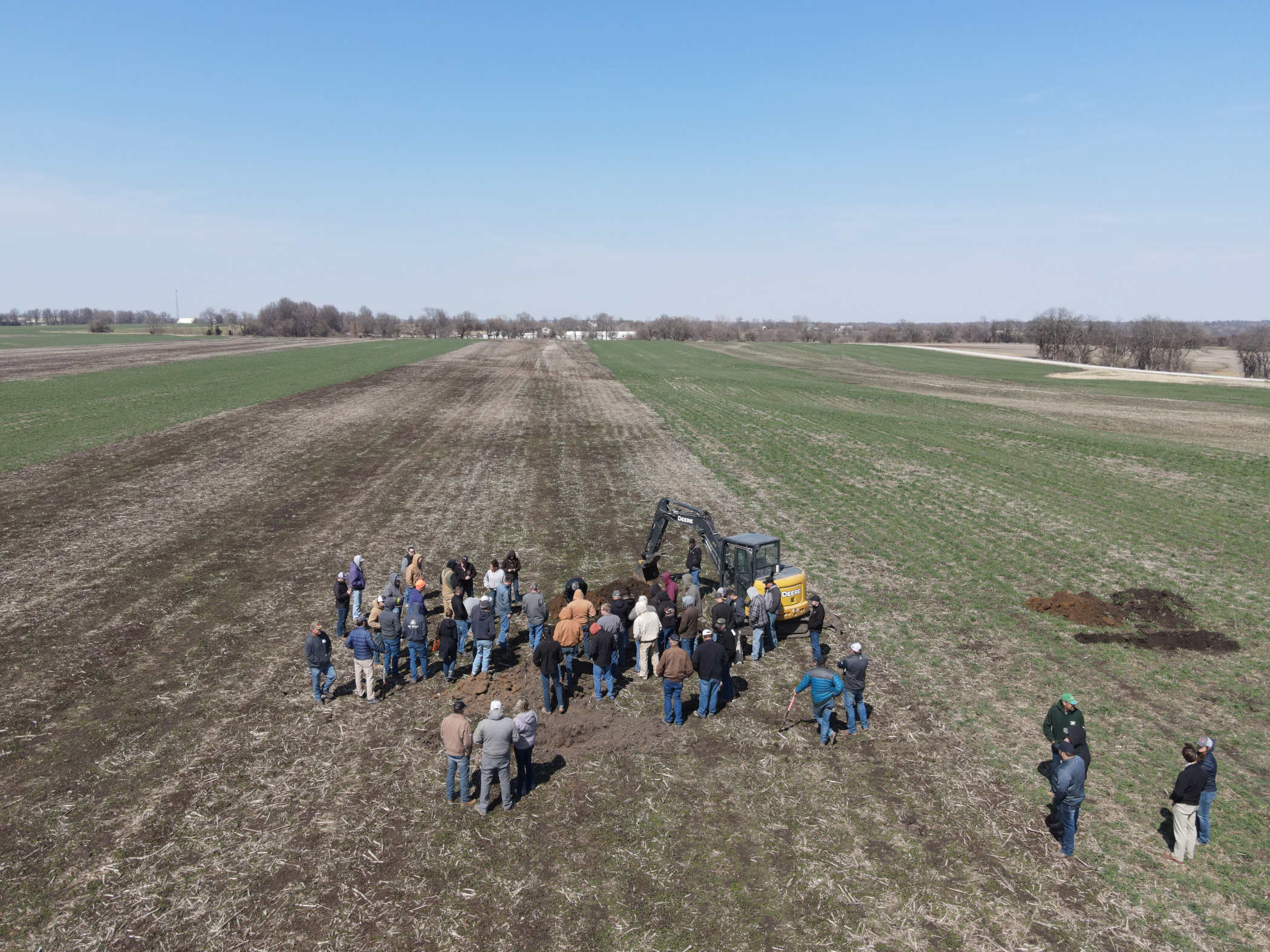 Farmers view a soil pit as part of an on-farm soil health research project. (NDSU photo)