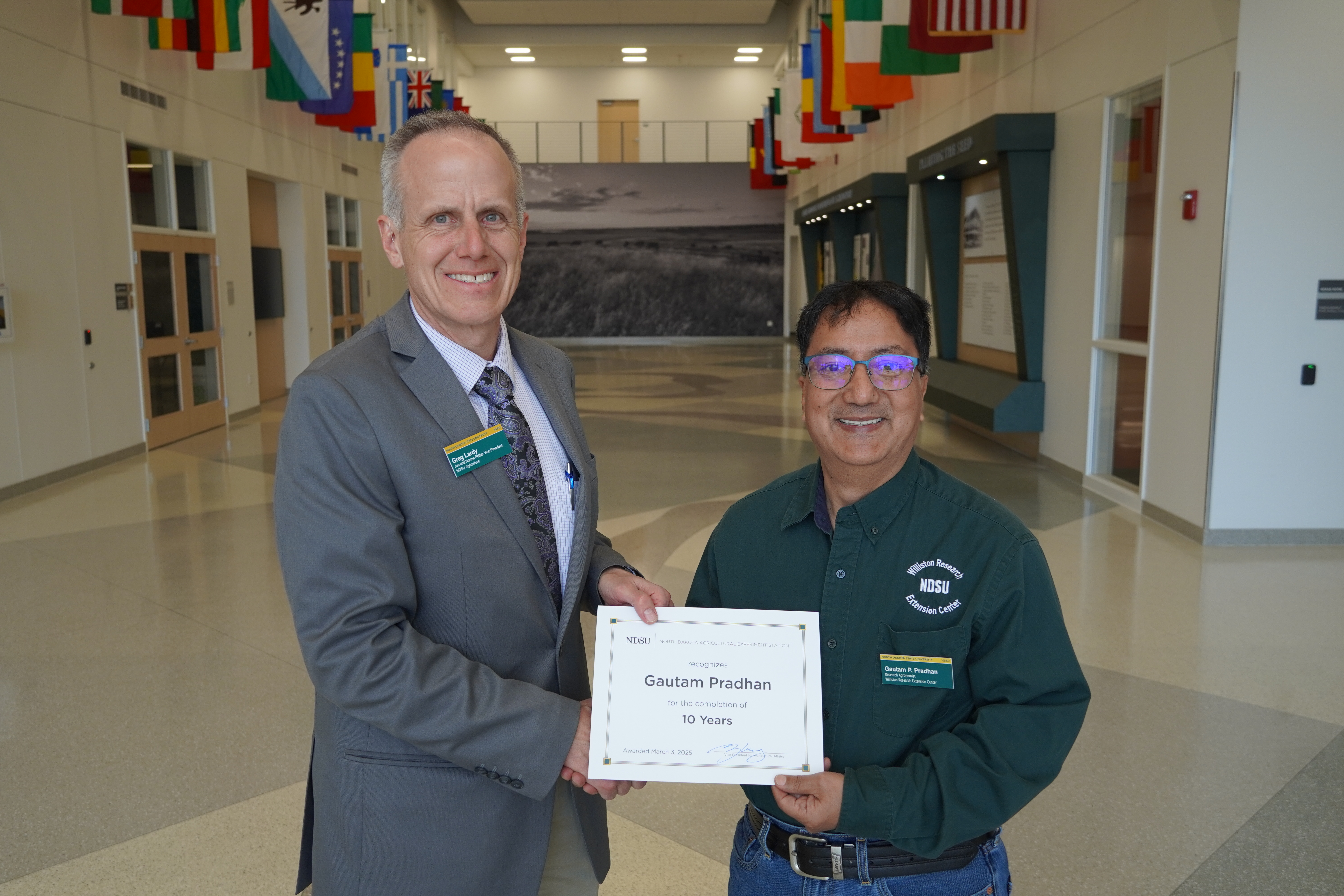 Gautam Pradhan (10 years) receives congratulations from Greg Lardy. (NDSU photo)