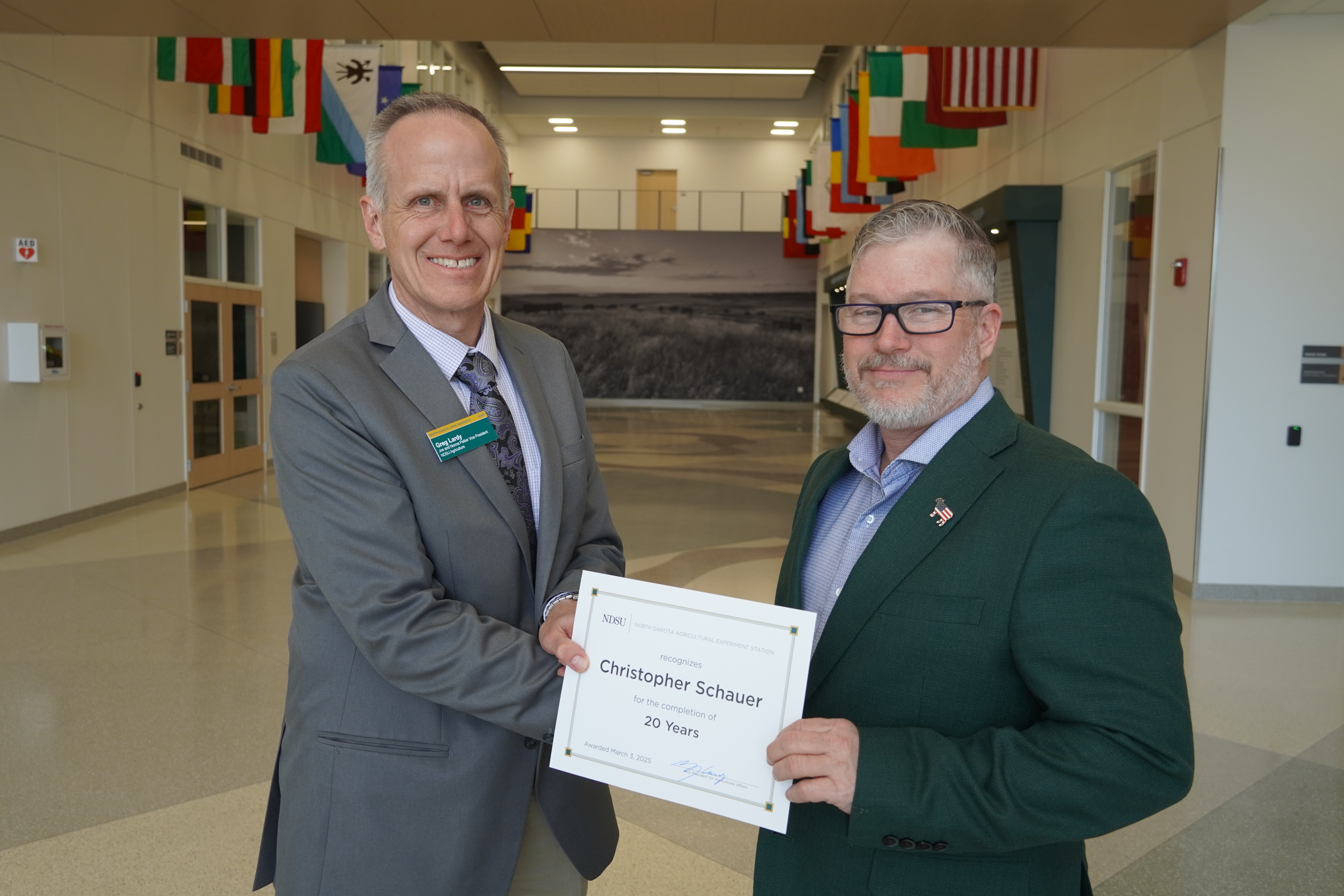 Christopher Schauer (20 years) receives congratulations from Greg Lardy. (NDSU photo)