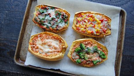Lasagna Stuffed Spaghetti Squash, fully cooked and placed on a baking sheet with parchment paper